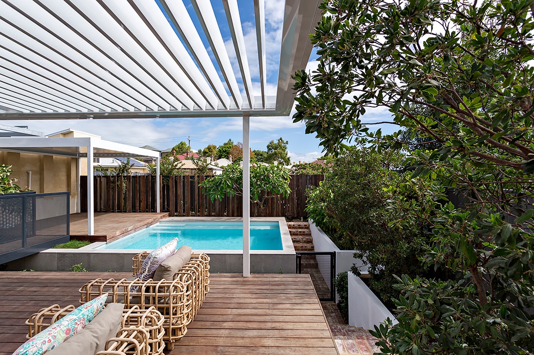 A rustic contemporary landscape with mixed textures, timber decking and a concrete pool.