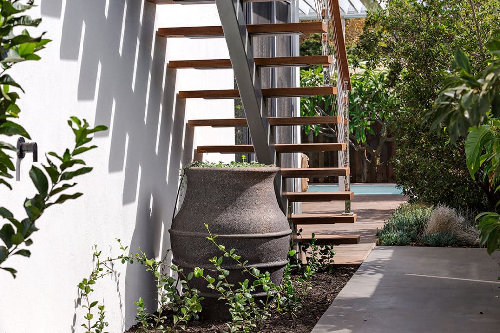 Landscape design accessories and planting beneath a staircase.